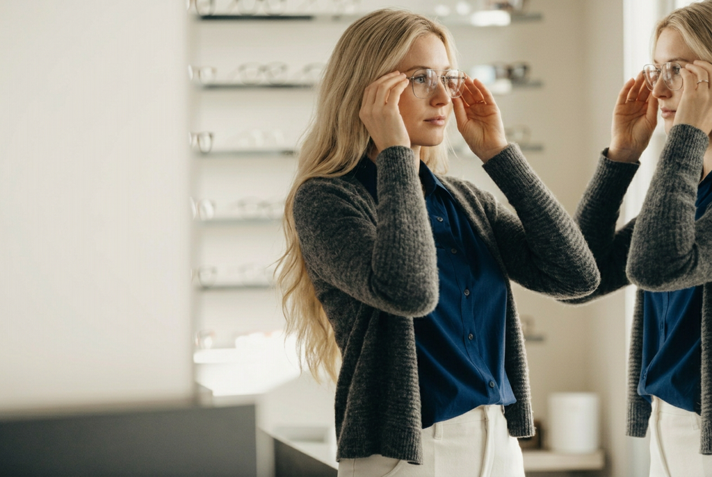 Woman at Eye Doctor picking out glasses.