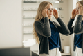 Woman at Eye Doctor picking out glasses.